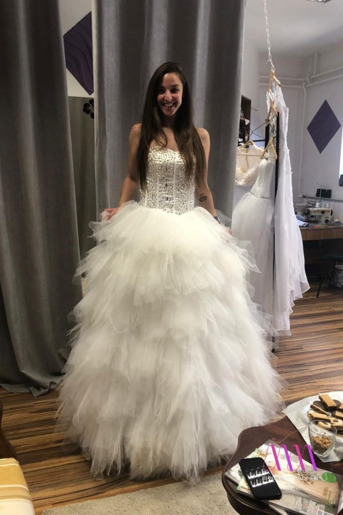 Amirah trying on a grand wedding dress in boutique