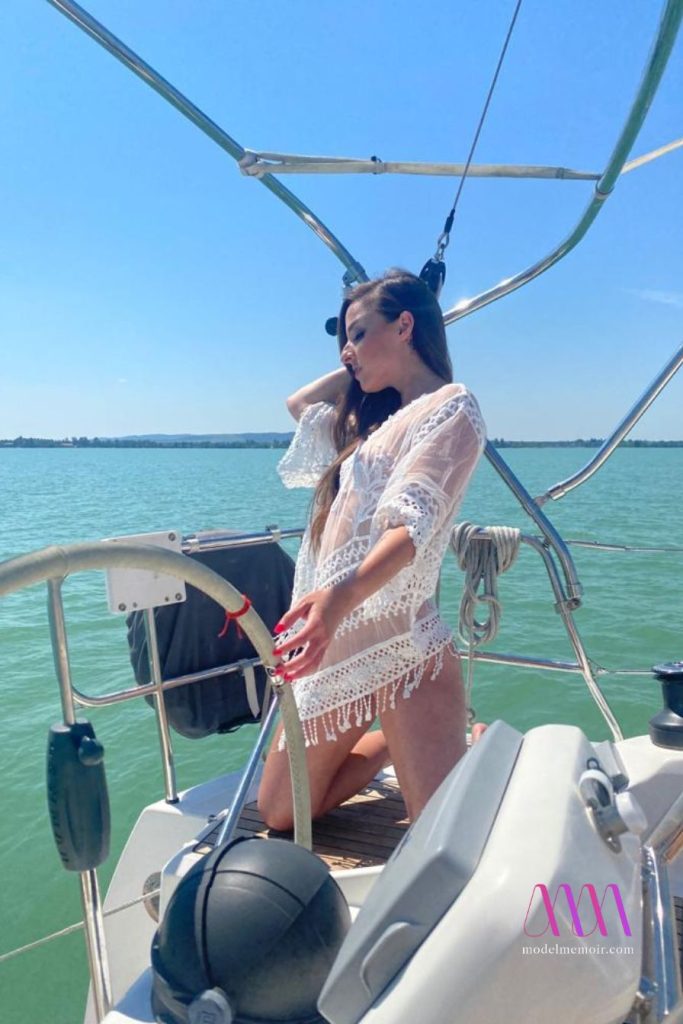 Amirah Adara standing on boat in stylish outfit