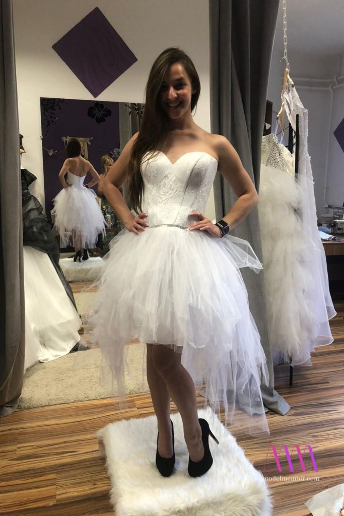 Amirah wearing a short wedding dress in boutique