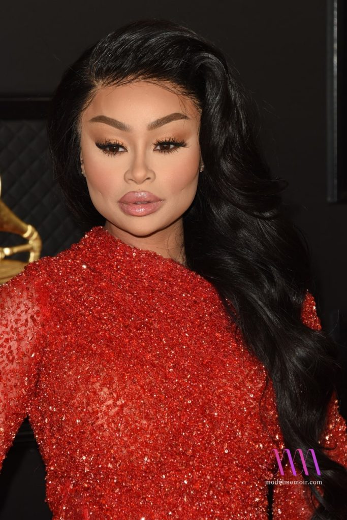 A photo of Blac Chyna wearing a red evening dress.