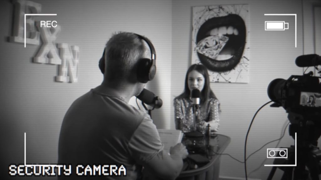 Liz Ocean recording interview on security camera.