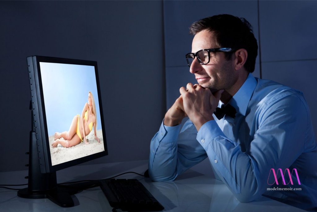 A man with glasses video chats with a beautiful young woman.