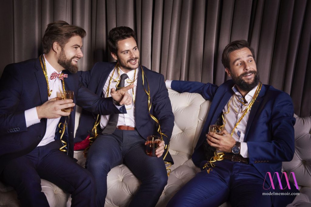 Three men enjoying themselves at a party.