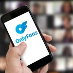 A photo of a phone screen showing OnlyFans logo.