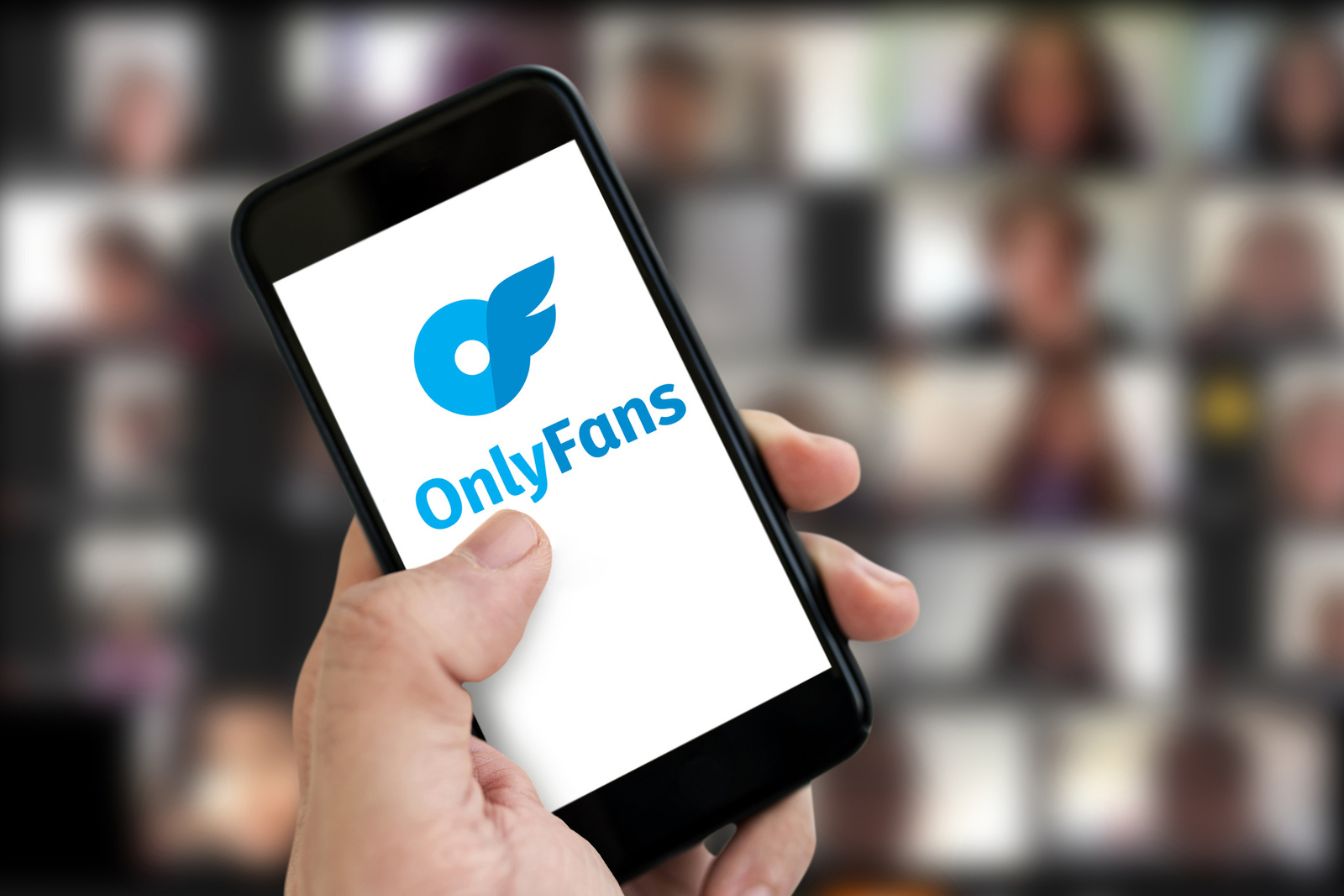 A photo of a phone screen showing OnlyFans logo.