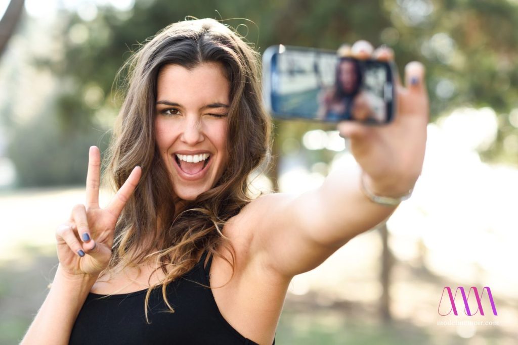 Beautiful young woman selfie in the park.