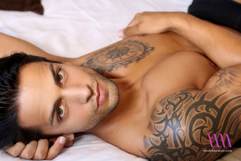 Sexy tattoed man in bed.